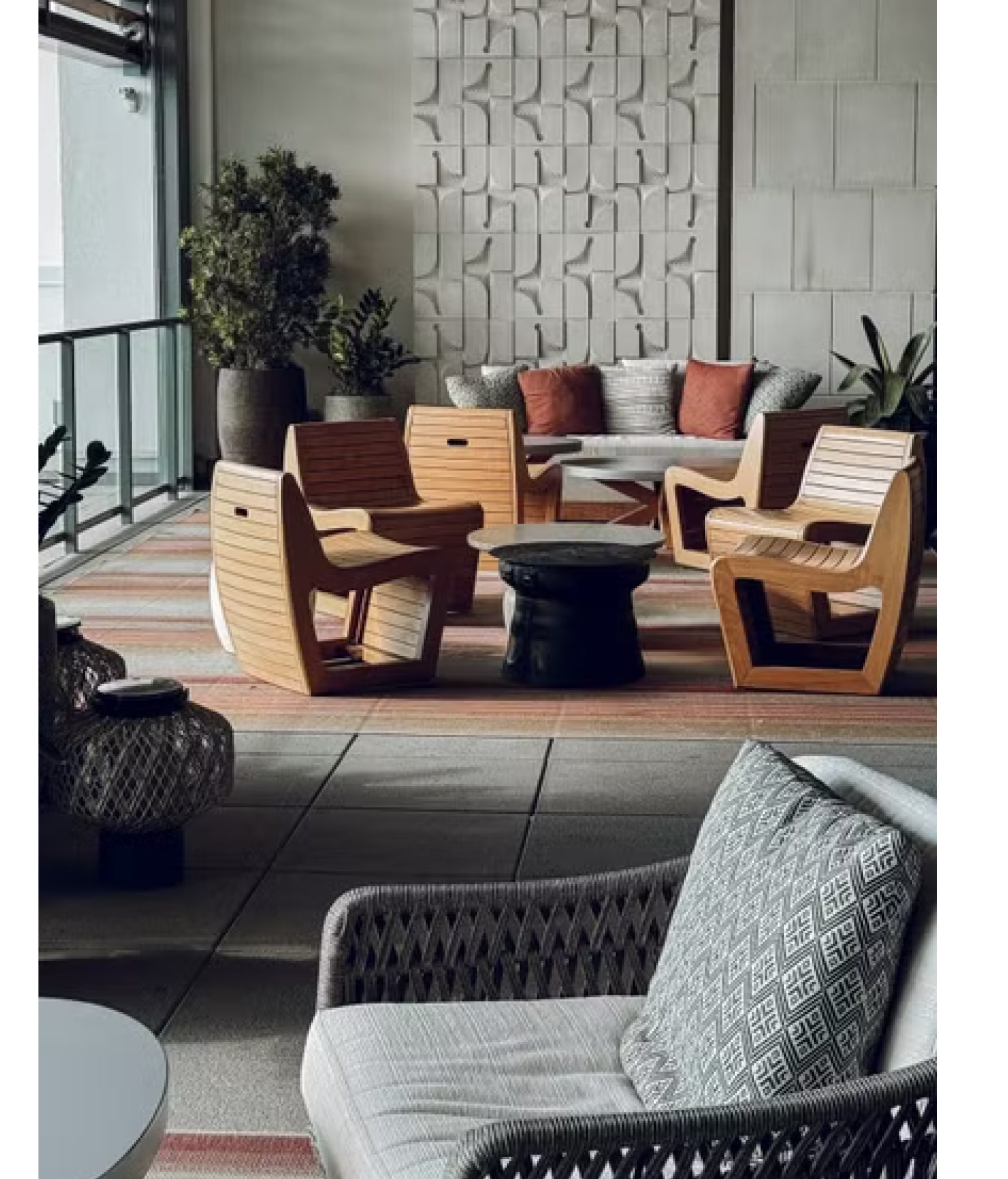 Woven lounge chairs in a shaded courtyard